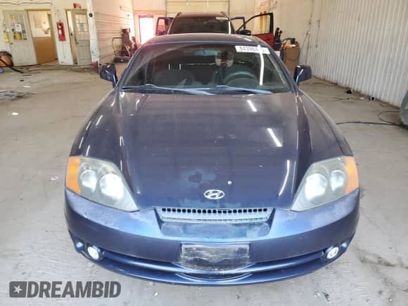 2004 Hyundai Tiburon GS z VIN KMHHM65D74U127053, wystawiony jako Copart lot #84396475 z przebiegiem 89 271 mil mil oraz Czysty tytuł • Clean title. Historia ofert i sprzedaży dostępna na DreamBid. Obrazek 5.