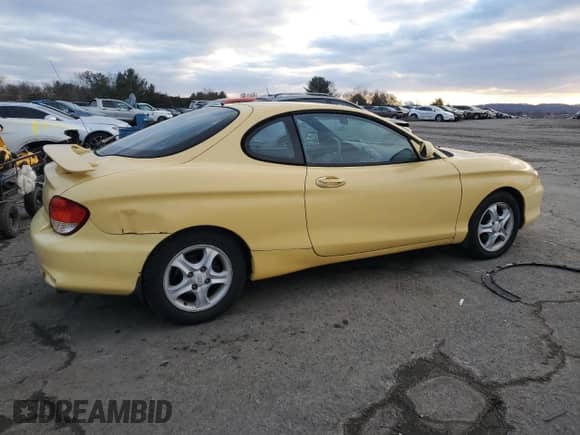 2001 Hyundai Tiburon с VIN KMHJG35F01U231789, выставлен на аукционе Copart как лот 88988265 с пробегом 106 946 миль миль и Чистый • Clean title. История ставок и продаж доступна на DreamBid. Изображение 3.