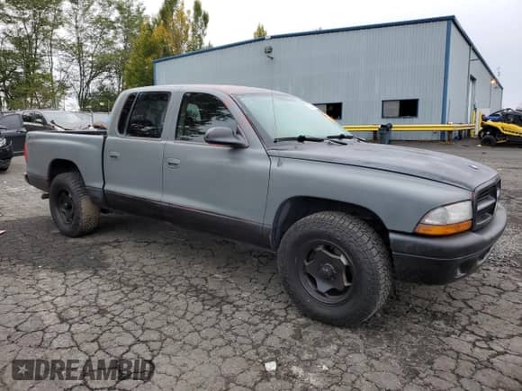 2003 Dodge Dakota Sport с VIN 1D7HL38N63S192308, выставлен на аукционе Copart как лот 77494684 с пробегом 128 512 миль миль и Списание • Salvage title. История ставок и продаж доступна на DreamBid. Изображение 4.