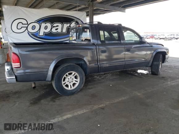 2003 Dodge Dakota SLT с VIN 1D7HL48N73S120149, выставлен на аукционе Copart как лот 80585795 с пробегом 205 262 миль миль и Списание • Salvage title. История ставок и продаж доступна на DreamBid. Изображение 3.