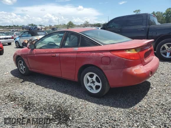 2001 Saturn SC with VIN 1G8ZY12791Z233074, listed as a Copart auction lot 60476085 with 130,323 mi miles and Salvage title. Bid and sale history available at DreamBid. Image 2.