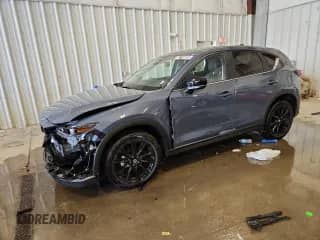 2025 Mazda CX-5 S Carbon Edition z VIN JM3KFBCMXS0672644, wystawiony jako Copart lot #82116095 z przebiegiem 9 046 mil mil oraz Czysty tytuł • Clean title. Historia ofert i sprzedaży dostępna na DreamBid. Obrazek 1.