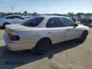 1996 Toyota Camry DX z VIN 4T1BG12K1TU751173, wystawiony jako Copart lot #69909135 z przebiegiem 134 247 mil mil oraz Szkoda całkowita • Salvage title. Historia ofert i sprzedaży dostępna na DreamBid. Obrazek 3.