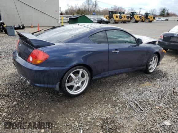 2004 Hyundai Tiburon GT с VIN KMHHN65F14U109145, выставлен на аукционе Copart как лот 51117385 с пробегом Не указан миль и Списание • Salvage title. История ставок и продаж доступна на DreamBid. Изображение 3.