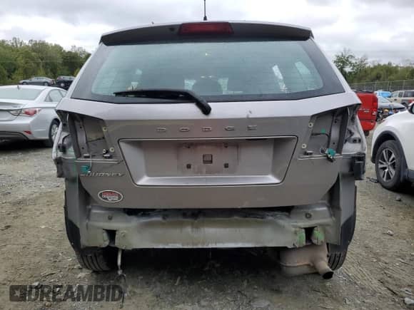 2015 Dodge Journey American Value with VIN 3C4PDCAB8FT708027, listed as a Copart auction lot 82297795 with 129,074 mi miles and Salvage title. Bid and sale history available at DreamBid. Image 6.