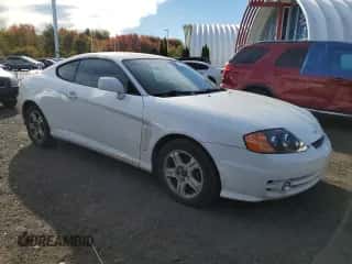 2003 Hyundai Tiburon GT с VIN KMHHN65FX3U096958, выставлен на аукционе Copart как лот 75451144 с пробегом 200 579 миль миль и Списание • Salvage title. История ставок и продаж доступна на DreamBid. Изображение 4.