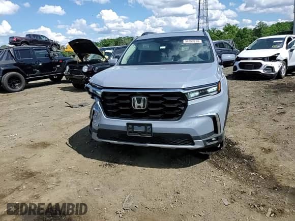 2023 Honda Pilot Elite with VIN 5FNYG1H82PB034130, listed as a Copart auction lot 56763214 with 7,710 mi miles and Salvage title. Bid and sale history available at DreamBid. Image 11.