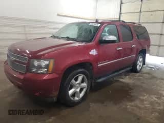 2010 Chevrolet Suburban LTZ with VIN 1GNUKKE31AR130285, listed as a Copart auction lot 52074615 with 173,017 mi miles and Salvage title. Bid and sale history available at DreamBid. Image 1.