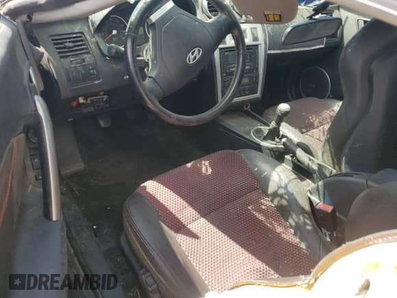 2006 Hyundai Tiburon GT с VIN KMHHN65FX6U191069, выставлен на аукционе Copart как лот 68652734 с пробегом Не указан миль и Чистый • Clean title. История ставок и продаж доступна на DreamBid. Изображение 8.
