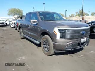2023 Ford F-150 Lightning Pro with VIN 1FTVW1EL0PWG22697, listed as a IAAI auction lot 43283386 with 28,534 mi miles and . Bid and sale history available at DreamBid. Image 1.