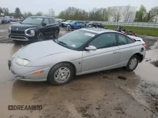 2001 Saturn SC with VIN 1G8ZR14721Z291764, listed as a Copart auction lot 55414785 with 215,943 mi miles and Salvage title. Bid and sale history available at DreamBid. Image 1.