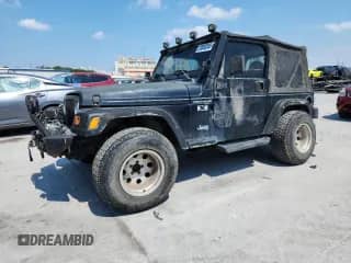 2002 Jeep Wrangler X z VIN 1J4FA39S72P735575, wystawiony jako Copart lot #70553245 z przebiegiem 153 615 mil mil oraz Szkoda całkowita • Salvage title. Historia ofert i sprzedaży dostępna na DreamBid. Obrazek 1.
