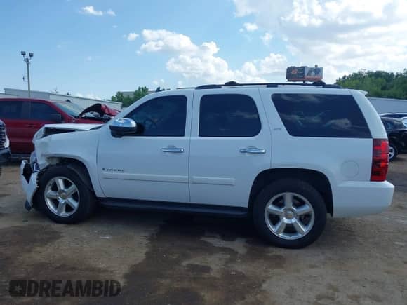 2007 Chevrolet Tahoe LTZ with VIN 1GNFC13027R338743, listed as a IAAI auction lot 43015789 with 168,315 mi miles and . Bid and sale history available at DreamBid. Image 14.