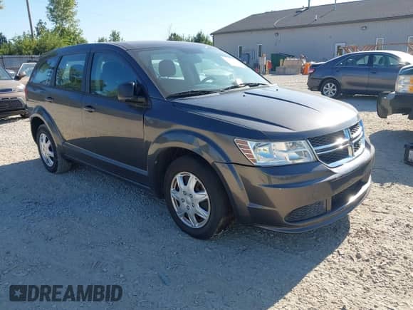 2015 Dodge Journey American Value z VIN 3C4PDCAB2FT692469, wystawiony jako IAAI lot #43076925 z przebiegiem 100 000 mil mil oraz . Historia ofert i sprzedaży dostępna na DreamBid. Obrazek 1.