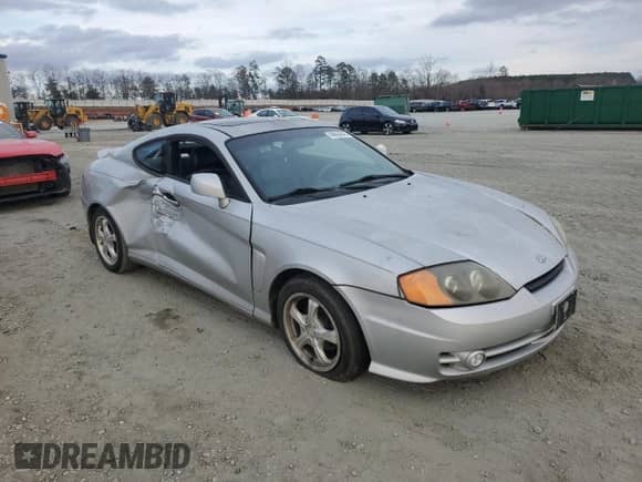 2003 Hyundai Tiburon GT с VIN KMHHN65F63U064962, выставлен на аукционе Copart как лот 44804045 с пробегом 186 171 миль миль и Списание • Salvage title. История ставок и продаж доступна на DreamBid. Изображение 4.