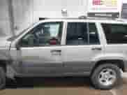 1996 Jeep Grand Cherokee Laredo z VIN 1J4GZ58S5TC293897, wystawiony jako IAAI lot #42435233 z przebiegiem 167 432 mil mil oraz . Historia ofert i sprzedaży dostępna na DreamBid. Obrazek 14.