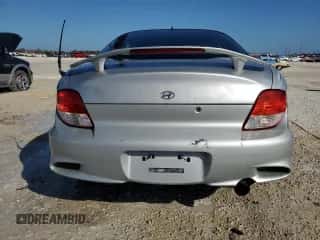 2001 Hyundai Tiburon с VIN KMHJG35F81U246024, выставлен на аукционе Copart как лот 77709294 с пробегом 127 057 миль миль и На запчасти • Non repairable. История ставок и продаж доступна на DreamBid. Изображение 6.