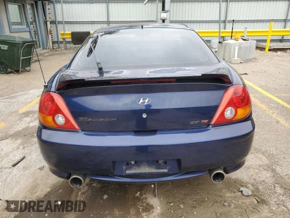 2003 Hyundai Tiburon GT with VIN KMHHN65F73U018847, listed as a Copart auction lot 58242385 with 164,976 mi miles and Salvage title. Bid and sale history available at DreamBid. Image 6.