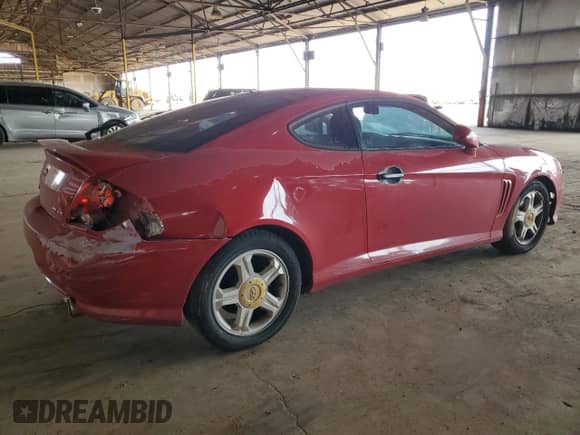 2003 Hyundai Tiburon GT z VIN KMHHN65F53U086483, wystawiony jako Copart lot #53391495 z przebiegiem 153 544 mil mil oraz Szkoda całkowita • Salvage title. Historia ofert i sprzedaży dostępna na DreamBid. Obrazek 3.