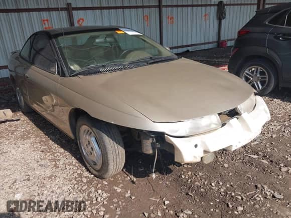 1997 Saturn 2dr Coupe with VIN 1G8ZH127XVZ333643, listed as a IAAI auction lot 42463504 with 104,295 mi miles and . Bid and sale history available at DreamBid. Image 1.