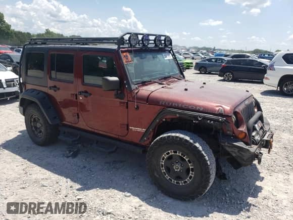 2007 Jeep Wrangler Unlimited Rubicon with VIN 1J4GA69127L155288, listed as a Copart auction lot 64615025 with 176,225 mi miles and Salvage title. Bid and sale history available at DreamBid. Image 4.