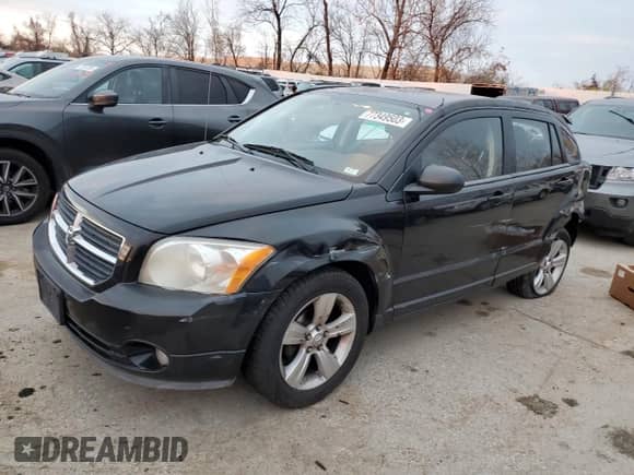 2010 Dodge Caliber Mainstreet with VIN 1B3CB3HAXAD551716, listed as a Copart auction lot 77349503 with 144,209 mi miles and Salvage title. Bid and sale history available at DreamBid. Image 1.