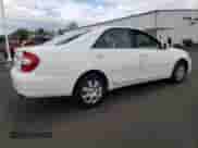 2002 Toyota Camry LE z VIN 4T1BE32K92U111356, wystawiony jako Copart lot #81428575 z przebiegiem 203 439 mil mil oraz Czysty tytuł • Clean title. Historia ofert i sprzedaży dostępna na DreamBid. Obrazek 3.