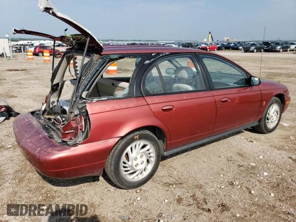1999 Saturn SW with VIN 1G8ZK827XXZ348270, listed as a Copart auction lot 67872244 with 110,936 mi miles and Salvage title. Bid and sale history available at DreamBid. Image 3.