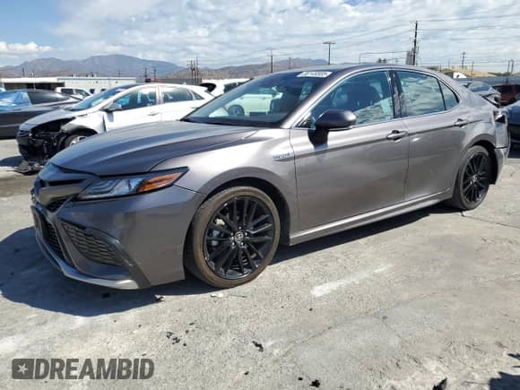 2021 Toyota Camry Hybrid XSE with VIN 4T1K31AK9MU565539, listed as a Copart auction lot 86149585 with 115,658 mi miles and Salvage title. Bid and sale history available at DreamBid. Image 1.