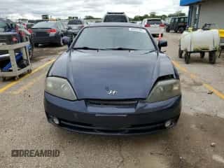 2003 Hyundai Tiburon GT с VIN KMHHN65F73U018847, выставлен на аукционе Copart как лот 58242385 с пробегом 164 976 миль миль и Списание • Salvage title. История ставок и продаж доступна на DreamBid. Изображение 5.