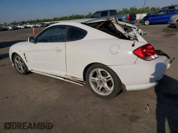 2006 Hyundai Tiburon GT z VIN KMHHN65F46U191990, wystawiony jako Copart lot #61887894 z przebiegiem 252 384 mil mil oraz Szkoda całkowita • Salvage title. Historia ofert i sprzedaży dostępna na DreamBid. Obrazek 2.