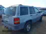 1996 Jeep Grand Cherokee Laredo z VIN 1J4GZ58S9TC245352, wystawiony jako IAAI lot #42860561 z przebiegiem Nie podano mil oraz . Historia ofert i sprzedaży dostępna na DreamBid. Obrazek 4.