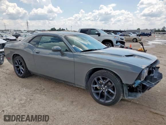 2023 Dodge Challenger SXT with VIN 2C3CDZAGXPH590946, listed as a Copart auction lot 71047015 with 34,719 mi miles and Salvage title. Bid and sale history available at DreamBid. Image 4.