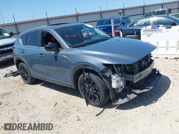 2022 Mazda CX-5 S Carbon Edition z VIN JM3KFBCM7N1543338, wystawiony jako IAAI lot #41994700 z przebiegiem 67 855 mil mil oraz . Historia ofert i sprzedaży dostępna na DreamBid. Obrazek 1.
