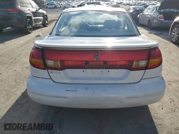 1999 Saturn SC with VIN 1G8ZR1275XZ375833, listed as a Copart auction lot 87960885 with 97,697 mi miles and Salvage title. Bid and sale history available at DreamBid. Image 6.