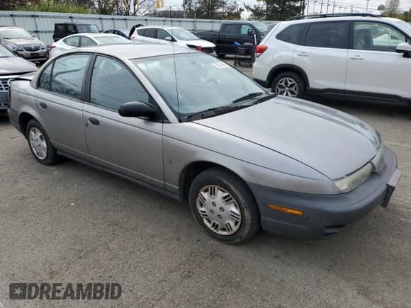 1999 Saturn SL with VIN 1G8ZH5286XZ266266, listed as a Copart auction lot 52543495 with 220,622 mi miles and Salvage title. Bid and sale history available at DreamBid. Image 4.