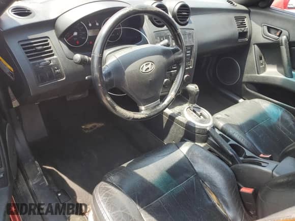 2003 Hyundai Tiburon GT с VIN KMHHN65F33U088538, выставлен на аукционе Copart как лот 54320955 с пробегом 220 732 миль миль и Списание • Salvage title. История ставок и продаж доступна на DreamBid. Изображение 8.