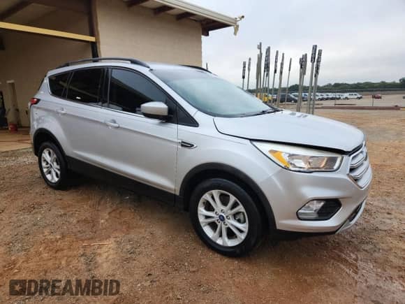 2018 Ford Escape SE with VIN 1FMCU9GD2JUB39549, listed as a Copart auction lot 84175385 with 127,811 mi miles and Salvage title. Bid and sale history available at DreamBid. Image 4.
