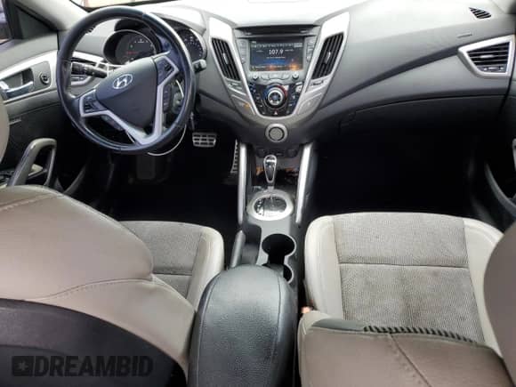 2014 Hyundai Veloster z VIN KMHTC6AD0EU196106, wystawiony jako Copart lot #69494305 z przebiegiem 102 472 mil mil oraz Szkoda całkowita • Salvage title. Historia ofert i sprzedaży dostępna na DreamBid. Obrazek 8.