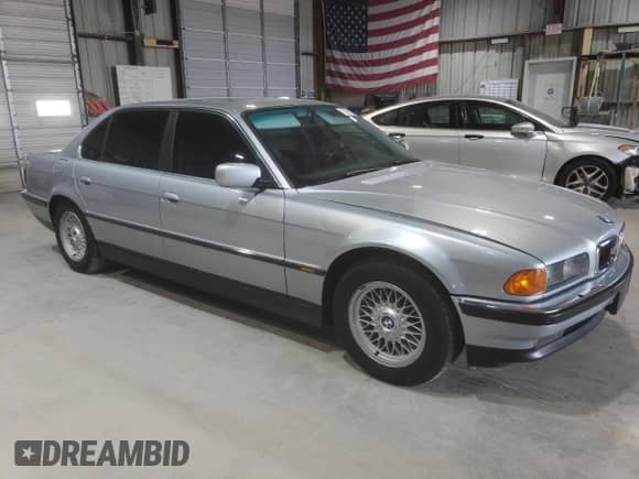 1997 BMW 7 Series 740iL with VIN WBAGJ8321VDM03554, listed as a Copart auction lot 71351095 with 143,449 mi miles and Salvage title. Bid and sale history available at DreamBid. Image 4.