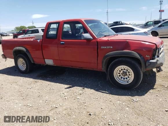 1990 Dodge Dakota z VIN 1B7FL23X0LS709073, wystawiony jako Copart lot #69897874 z przebiegiem 147 052 mil mil oraz Szkoda całkowita • Salvage title. Historia ofert i sprzedaży dostępna na DreamBid. Obrazek 4.