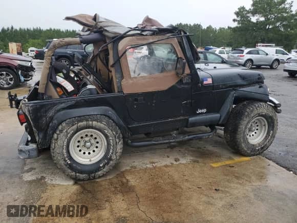 2002 Jeep Wrangler Sahara with VIN 1J4FA59SX2P747327, listed as a Copart auction lot 59515455 with 79,964 mi miles and Salvage title. Bid and sale history available at DreamBid. Image 3.