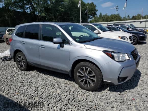 2018 Subaru Forester Premium with VIN JF2SJGECXJH411587, listed as a Copart auction lot 68100385 with 99,274 mi miles and Salvage title. Bid and sale history available at DreamBid. Image 4.