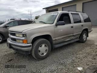 1999 Chevrolet Tahoe Z71 with VIN 1GNEK13R9XJ504722, listed as a Copart auction lot 61067465 with 215,951 mi miles and Salvage title. Bid and sale history available at DreamBid. Image 1.