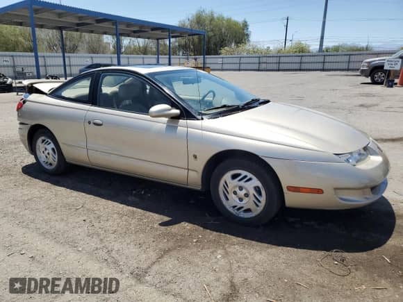 1999 Saturn SC with VIN 1G8ZY1277XZ299213, listed as a Copart auction lot 63788405 with 54,699 mi miles and Salvage title. Bid and sale history available at DreamBid. Image 4.