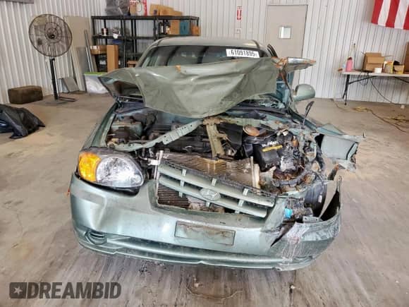 2005 Hyundai Accent GLS z VIN KMHCG35CX5U335467, wystawiony jako Copart lot #61091895 z przebiegiem Nie podano mil oraz Szkoda całkowita • Salvage title. Historia ofert i sprzedaży dostępna na DreamBid. Obrazek 5.