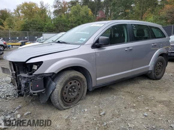 2015 Dodge Journey American Value with VIN 3C4PDCAB8FT708027, listed as a Copart auction lot 82297795 with 129,074 mi miles and Salvage title. Bid and sale history available at DreamBid. Image 1.