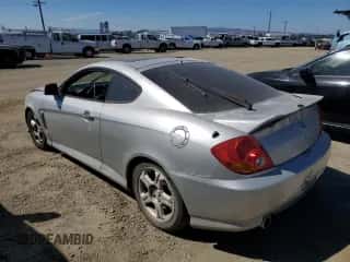 2003 Hyundai Tiburon GT с VIN KMHHN65F83U024950, выставлен на аукционе Copart как лот 70780994 с пробегом 178 681 миль миль и Списание • Salvage title. История ставок и продаж доступна на DreamBid. Изображение 2.