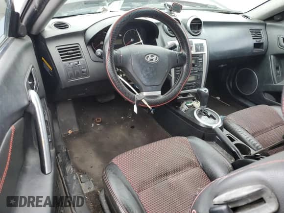 2005 Hyundai Tiburon GT с VIN KMHHN65F35U174824, выставлен на аукционе Copart как лот 81582545 с пробегом Не указан миль и Списание • Salvage title. История ставок и продаж доступна на DreamBid. Изображение 8.