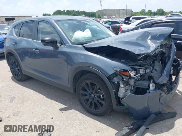 2022 Mazda CX-5 S Carbon Edition z VIN JM3KFBCM2N0571117, wystawiony jako IAAI lot #42535593 z przebiegiem 33 735 mil mil oraz . Historia ofert i sprzedaży dostępna na DreamBid. Obrazek 1.